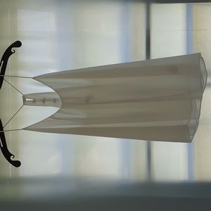 A Norah brand white sleeveless shirt, size M.